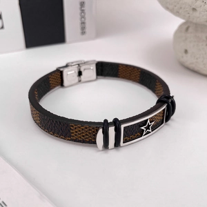 Macro shot of men's leather bracelet with star metal plate and checkered pattern texture