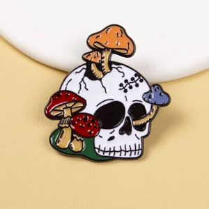 Gothic punk skull enamel brooch pin featuring colorful mushrooms on textured background