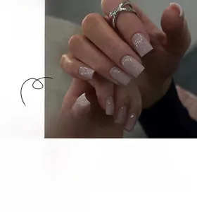 Detail of short square press on nails in pale pink with silver glitter finish