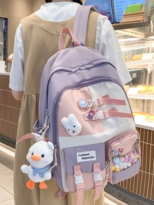 Cute pastel purple and pink school backpack for girls with plush animal pendants