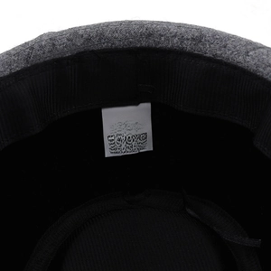 Detail of wool fedora inner care label showing 58cm size and fabric composition