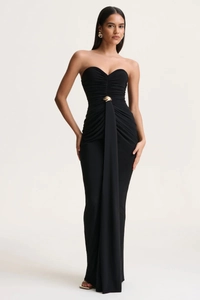 Detail of ruched bodice with golden buckle on elegant black strapless floor-length dress
