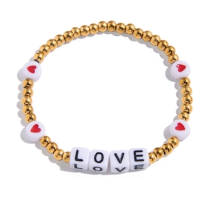 Detail of beaded friendship bracelet featuring gold beads and white LOVE letter cubes