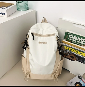 Detail view of large capacity nylon backpack in white and beige with side mesh pockets
