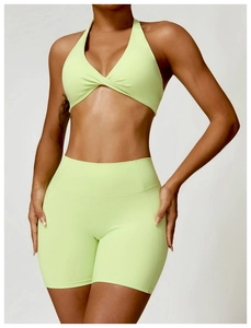 Détail de l'ensemble vert néon avec short taille haute et brassière de sport croisée