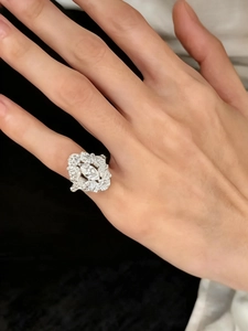 Close-up of silver marquise zircon ring with intricate lace cluster design on hand