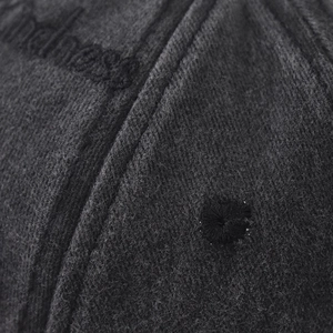 Detail of grey washed baseball cap showing premium stitching and kindness embroidery