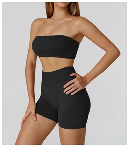 Detail of black seamless ribbed yoga set featuring bandeau top and high waist sports shorts