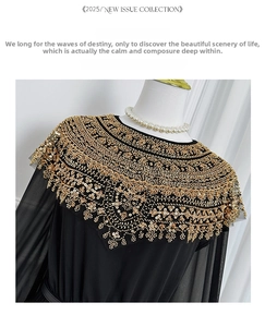 Detail of elegant gold beadwork and sequins on the collar of a black pleated chiffon dress