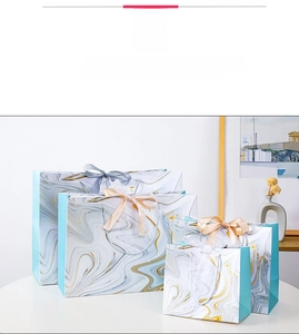 Detailed set of marble patterned gift bags in various sizes with silk ribbon bows