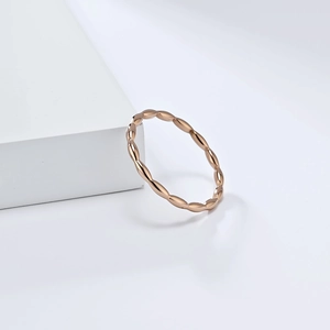 Elegant rose gold minimalist ring with interlocking geometric teardrop design on white cube