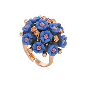 Floral ring set featuring blue and pink resin flowers with crystals and gold band