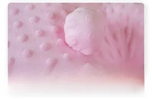 Close-up of soft pink bubble plush fabric texture with raised 3D sensory dots