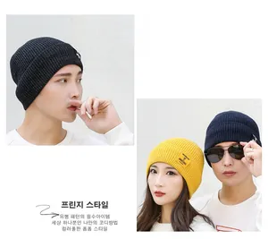 Close-up of ribbed knit beanie featuring contrasting brand label and vertical texture