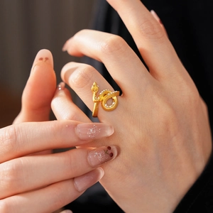 Macro shot of gold-plated snake ring featuring sparkling crystals and a coiled design