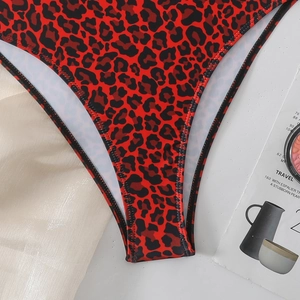 Close-up of red and black leopard print swimsuit with neat black edge stitching