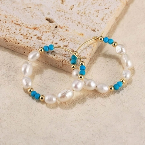 Detail shot of bohemian hoop earrings with white freshwater pearls and blue turquoise beads