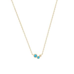 Detail of gold necklace featuring turquoise stones and micro-diamond with beaded edges