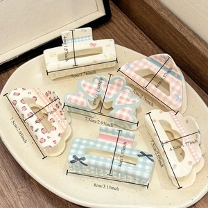 Floral and checkered hair claw clips set with bow detail for elegant hair styling