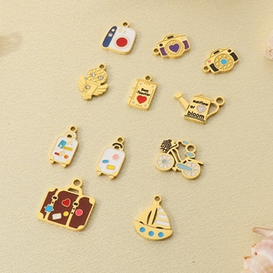 Detailed macro view of colorful enamel charms like camera and suitcase for DIY jewelry making