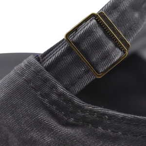 Close-up of washed cotton baseball cap with adjustable antique brass metal buckle