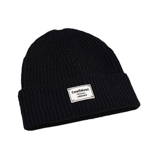 Classic black ribbed knit beanie with a white woven patch for women's winter warmth