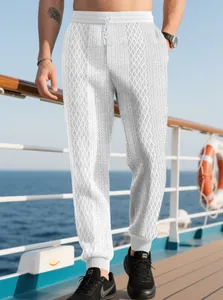Men's white waffle knit jogger pants with geometric patterns and drawstring waist