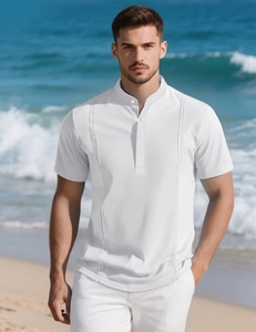 Detailed view of white men's short sleeve shirt with lace cutout trim on beachfront