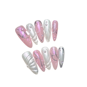 Pink and silver cat-eye press-on nails with 3D shell texture and rhinestone details