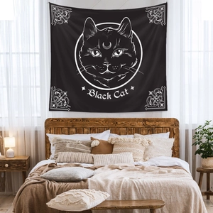 Detail of bedroom wall tapestry featuring a black cat design and artistic text patterns