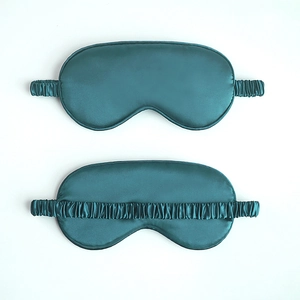 Dark green satin sleep eye mask with elastic head strap shown on white background