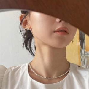 Detailed close-up of a 925 sterling silver freshwater pearl necklace and stud earrings set