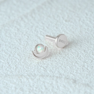 Macro shot of S925 sterling silver crescent stud earring with iridescent opal inlay