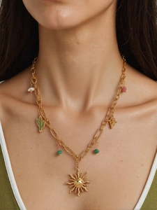 Detail of gold necklace featuring sun, cactus, and starfish charms with colorful beads