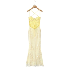 Detailed view of yellow lace floral embroidery and adjustable back cross-strap ties