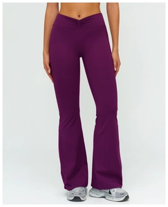 Close-up of deep purple high-waisted flare leggings with a V-shaped ruched waist detail