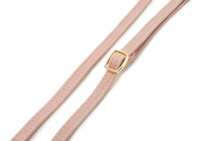 Close-up of adjustable pink faux leather shoulder strap with golden metal buckle detail