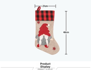 Close-up of a gnome Christmas stocking with red plaid cuff and detailed embroidery