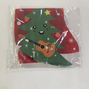 Detail of a red fabric Christmas stocking featuring a cartoon tree playing a guitar