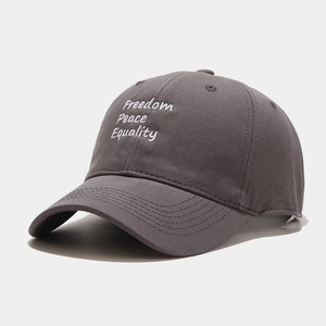 Detail of dark grey cotton baseball cap with white Freedom Peace Equality embroidery