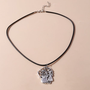 Detail of Halloween necklace featuring silver spider web, spider, and witch charms on black cord