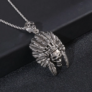 Close-up of vintage silver Indian chief skull pendant with feather detail on chain