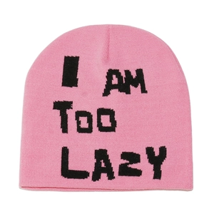Detailed knit texture of pink beanie featuring bold black I AM TOO LAZY slogan