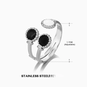 Detail view of adjustable stainless steel geometric ring with black and white enamel finish