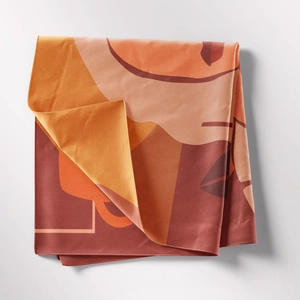 Detail of bohemian tapestry fabric showing modern abstract warm-toned geometric patterns
