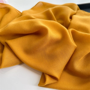 Detailed macro view of yellow cotton linen fabric texture with soft natural pleats