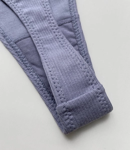 Detailed macro shot of fine purple ribbed cotton fabric and stitching on a thong