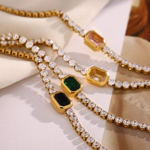 Detail of 18K gold plated tennis bracelets with pink, green, black and white zircons