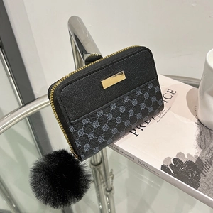 Black patchwork coin purse with clover pattern, gold trim and faux fur pompom keychain
