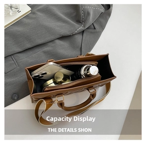 Interior view of brown quilted bag showing storage for phone, lipstick and water bottle